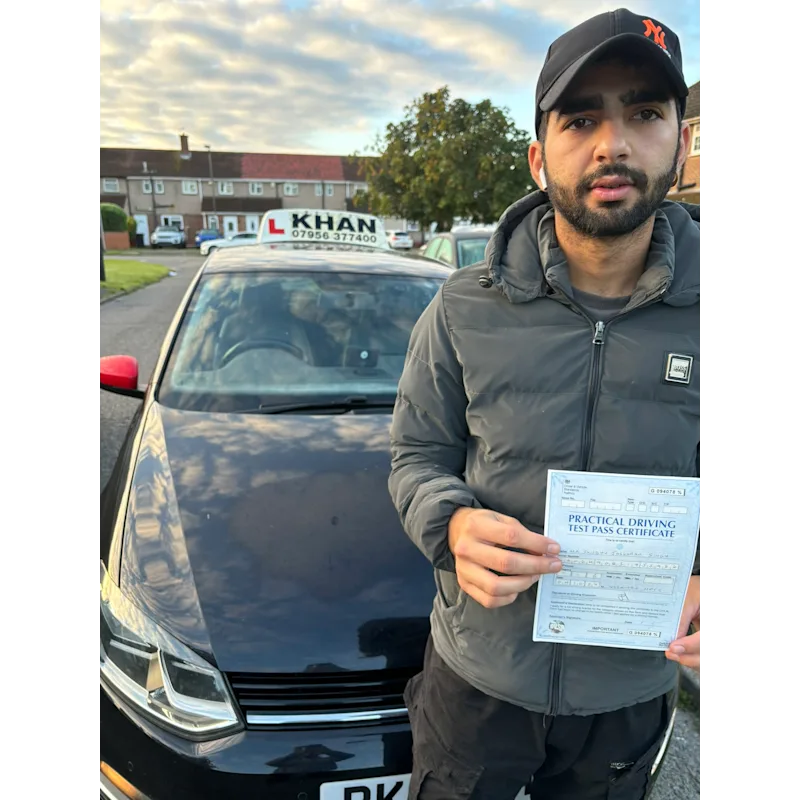 Learner driver celebrating passing their driving test with Khan School of Motoring