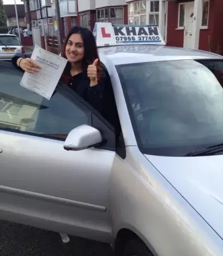 Learner driver celebrating passing their driving test with Khan School of Motoring