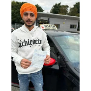 Learner driver celebrating passing their driving test with Khan School of Motoring