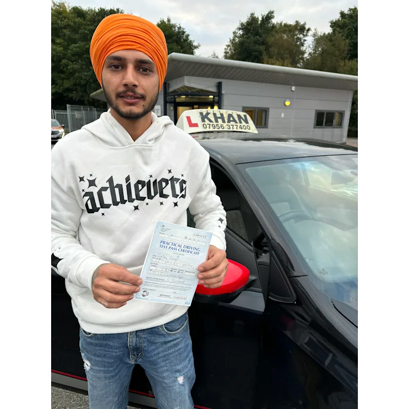 Learner driver celebrating passing their driving test with Khan School of Motoring