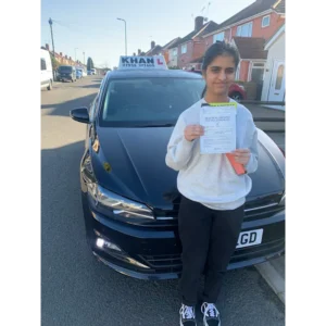 Pupil proudly showing pass certificate after driving lessons
