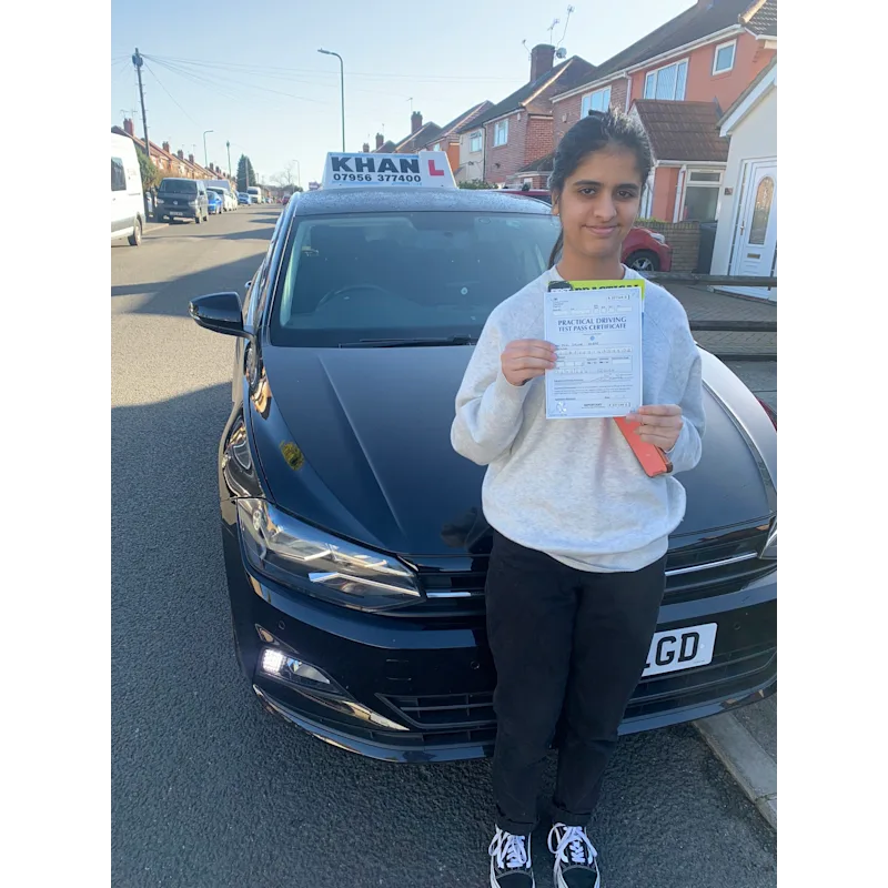 Pupil proudly showing pass certificate after driving lessons