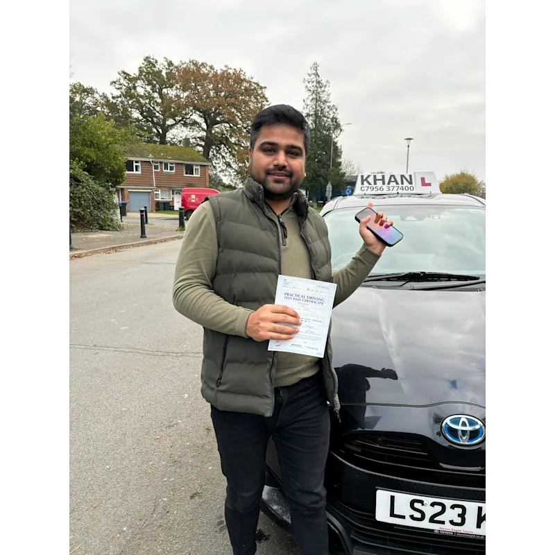 Learner driver celebrating passing their driving test with Khan School of Motoring