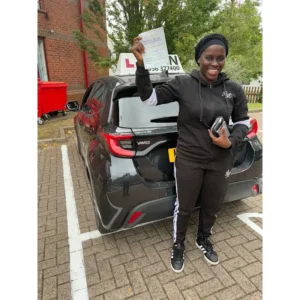 Happy pupil holding driving test pass certificate after lessons in Slough