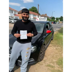 Pupil proudly showing pass certificate after driving lessons
