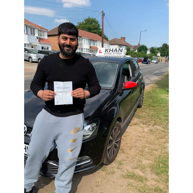 Pupil proudly showing pass certificate after driving lessons