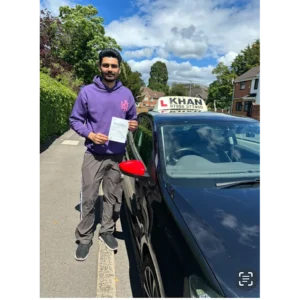 Learner driver celebrating passing their driving test with Khan School of Motoring
