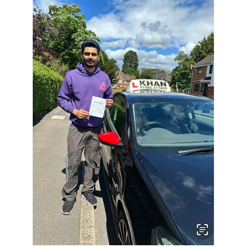 Learner driver celebrating passing their driving test with Khan School of Motoring