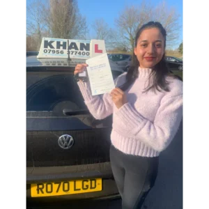 Pupil proudly showing pass certificate after driving lessons