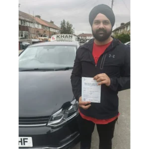 Happy pupil holding driving test pass certificate after lessons in Slough