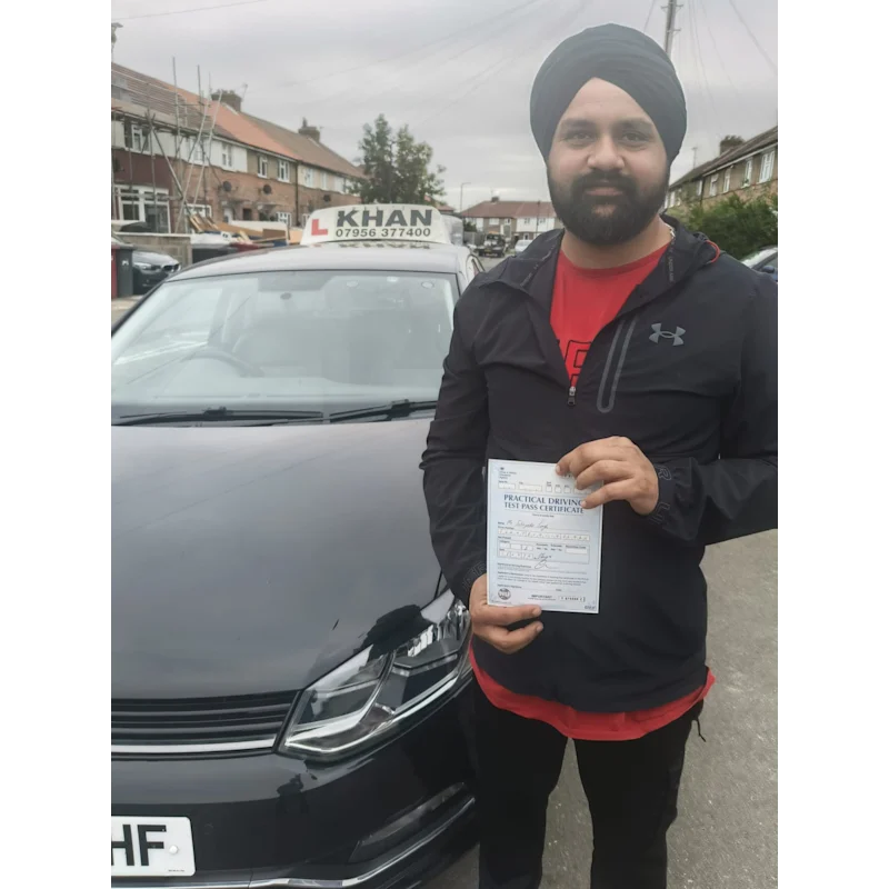 Happy pupil holding driving test pass certificate after lessons in Slough