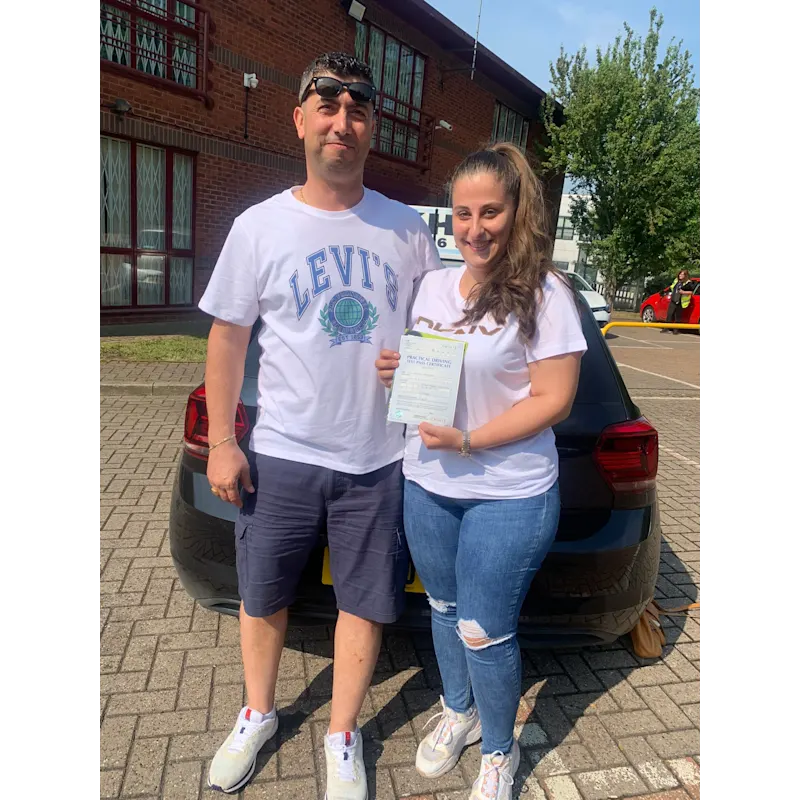 Pupil proudly showing pass certificate after driving lessons