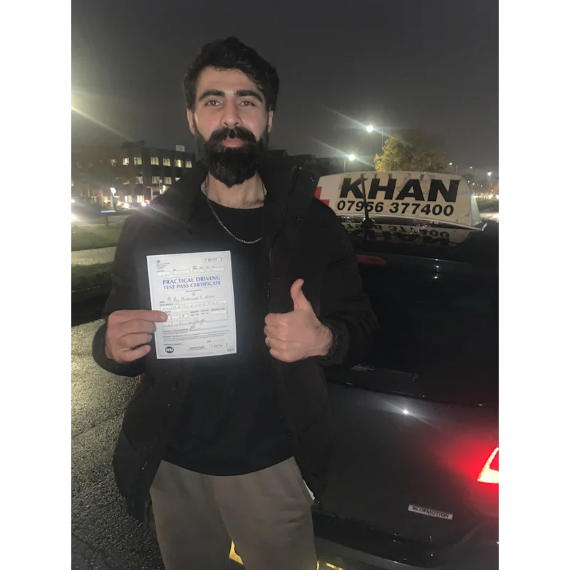 Pupil proudly showing pass certificate after driving lessons