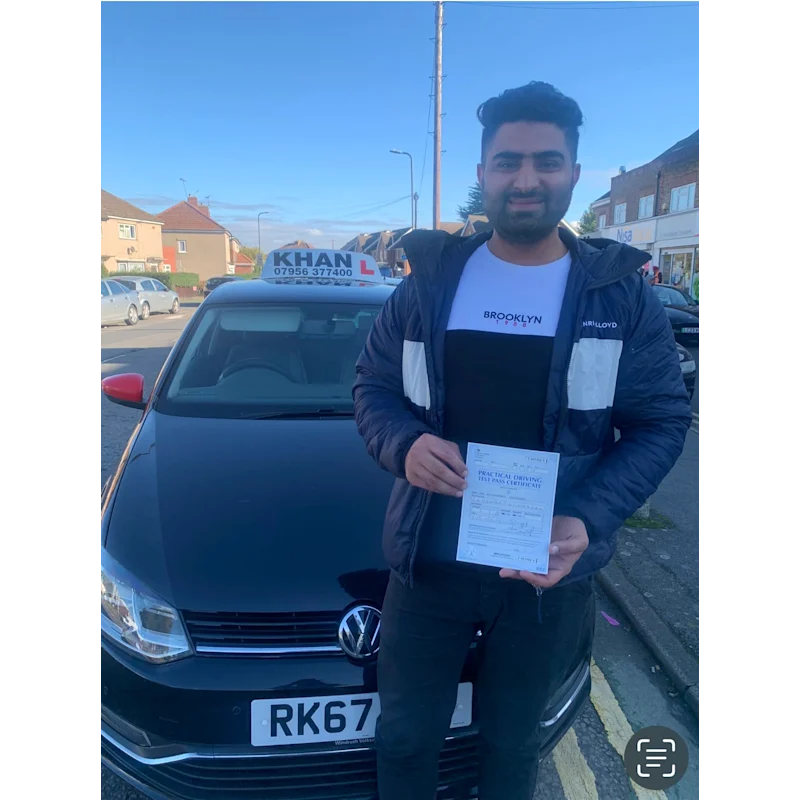 Pupil proudly showing pass certificate after driving lessons