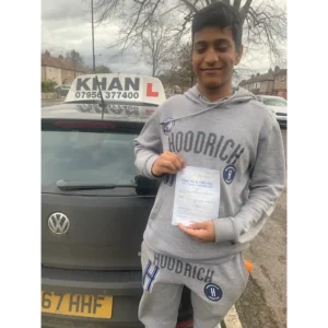 Pupil proudly showing pass certificate after driving lessons