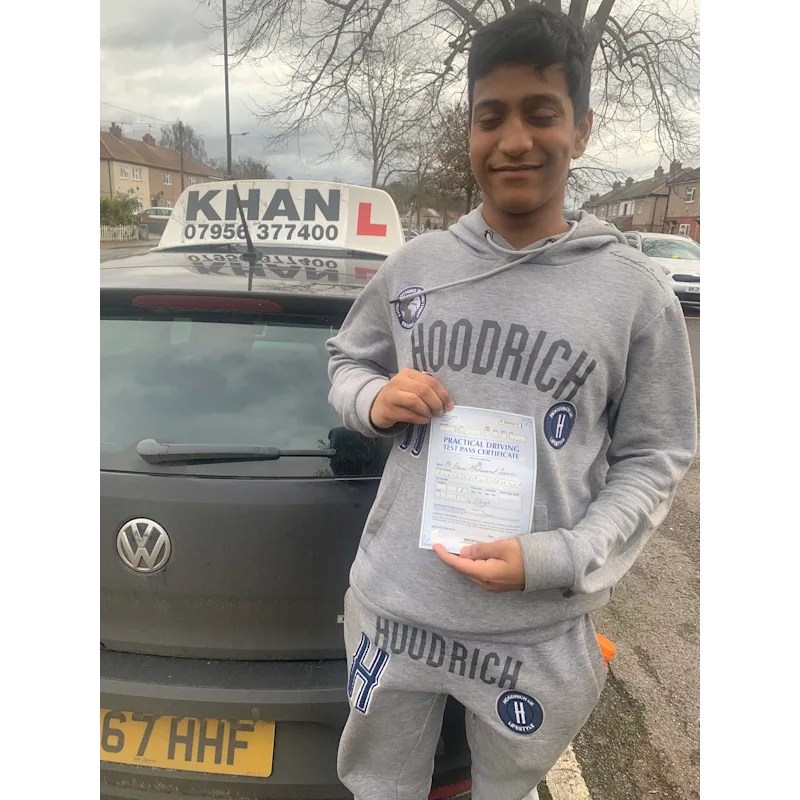 Pupil proudly showing pass certificate after driving lessons