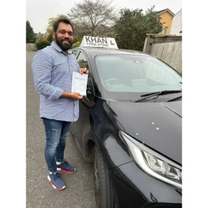 Learner driver celebrating passing their driving test with Khan School of Motoring