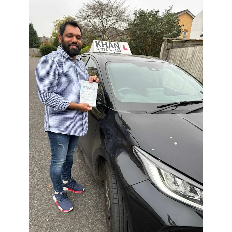 Learner driver celebrating passing their driving test with Khan School of Motoring
