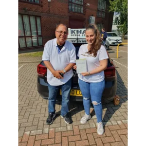 Pupil proudly showing pass certificate after driving lessons