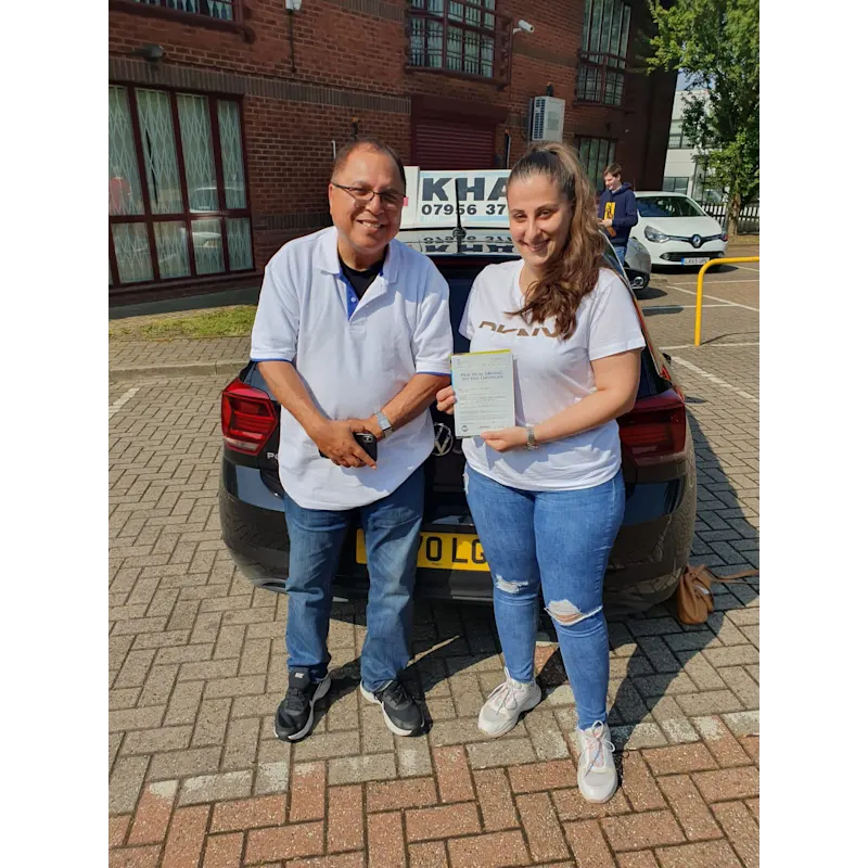 Pupil proudly showing pass certificate after driving lessons