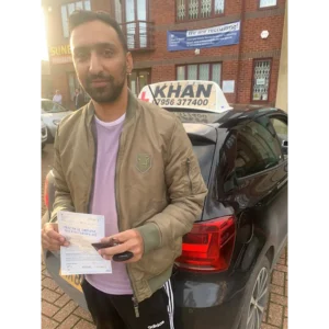 Pupil proudly showing pass certificate after driving lessons