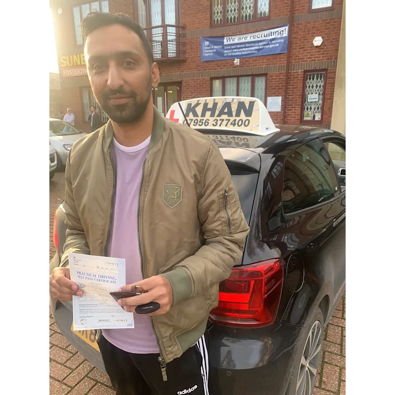 Pupil proudly showing pass certificate after driving lessons